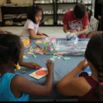 Children practicing fine motor skills with crafting